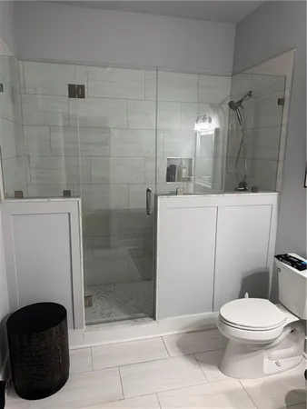 a bathroom with a toilet and a shower