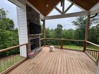 a view of balcony with wooden floor and fence