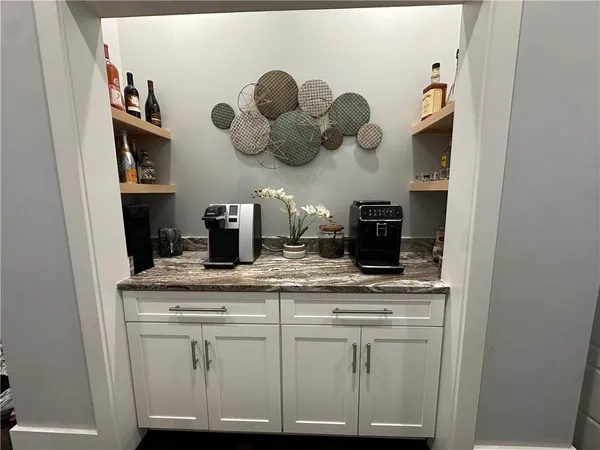 a kitchen with white cabinets and a sink