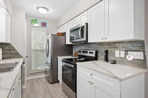 2003 North Fulton Beach Road, Unit 43 Rockport, TX 78382 - Photo 5 of 30 Kitchen was updated with newly installed cabinets, stainless steel applicances and quartz countertops and updated backsplash. Refrigerator stays with property.