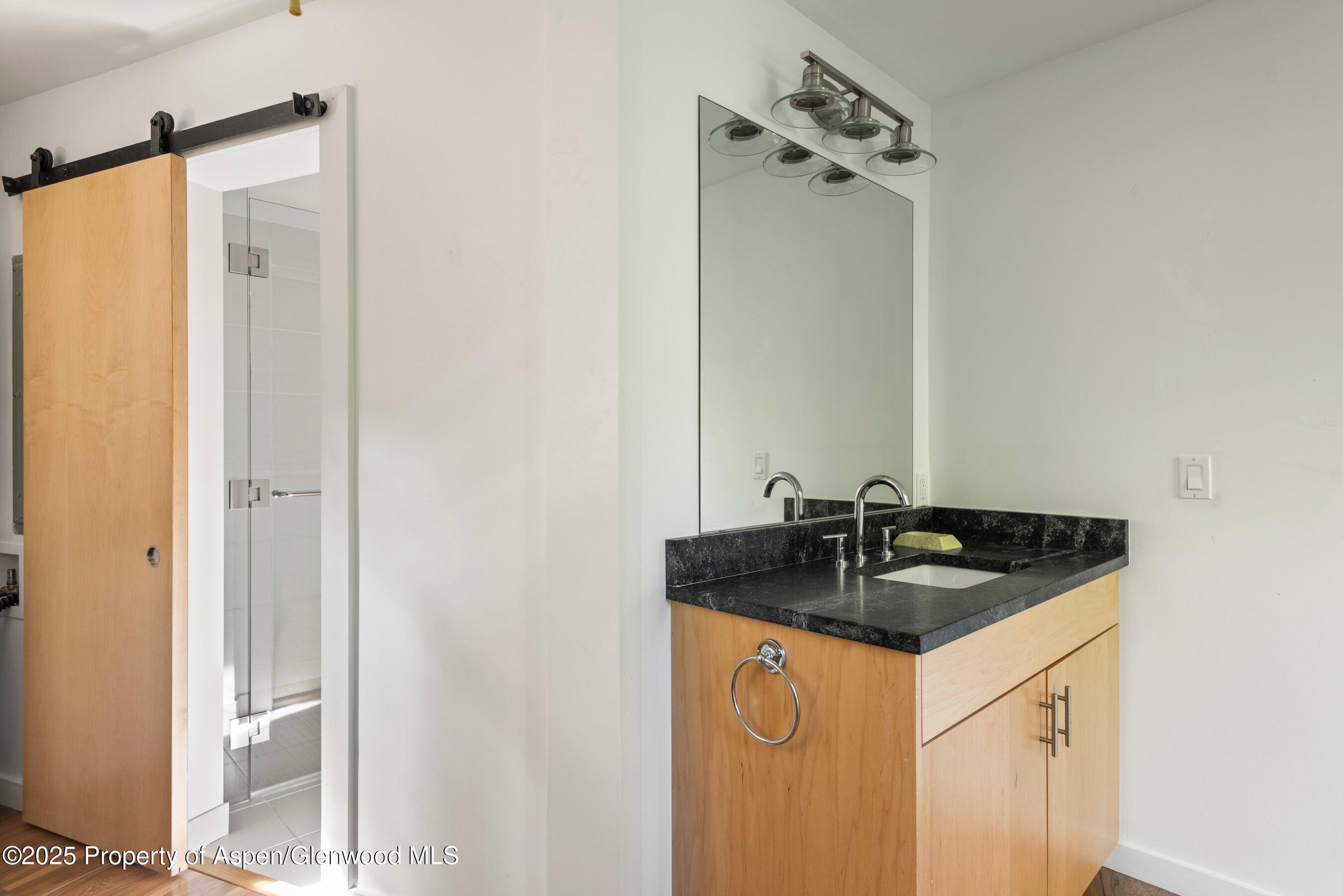 768 Kings Lake Road Basalt, CO 81621 - Photo 20 of 42 a bathroom with a granite countertop sink and a mirror