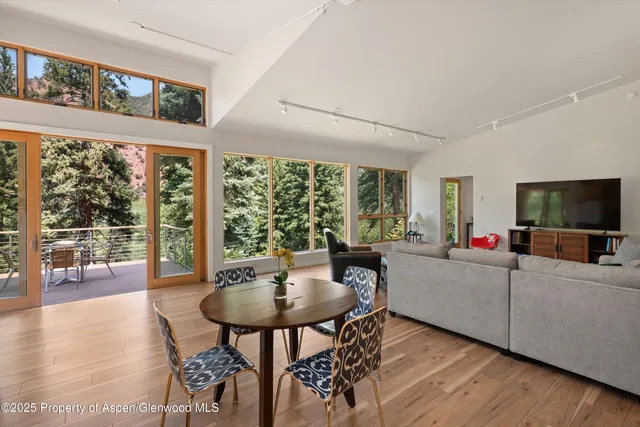 a kitchen with sink a window and chairs