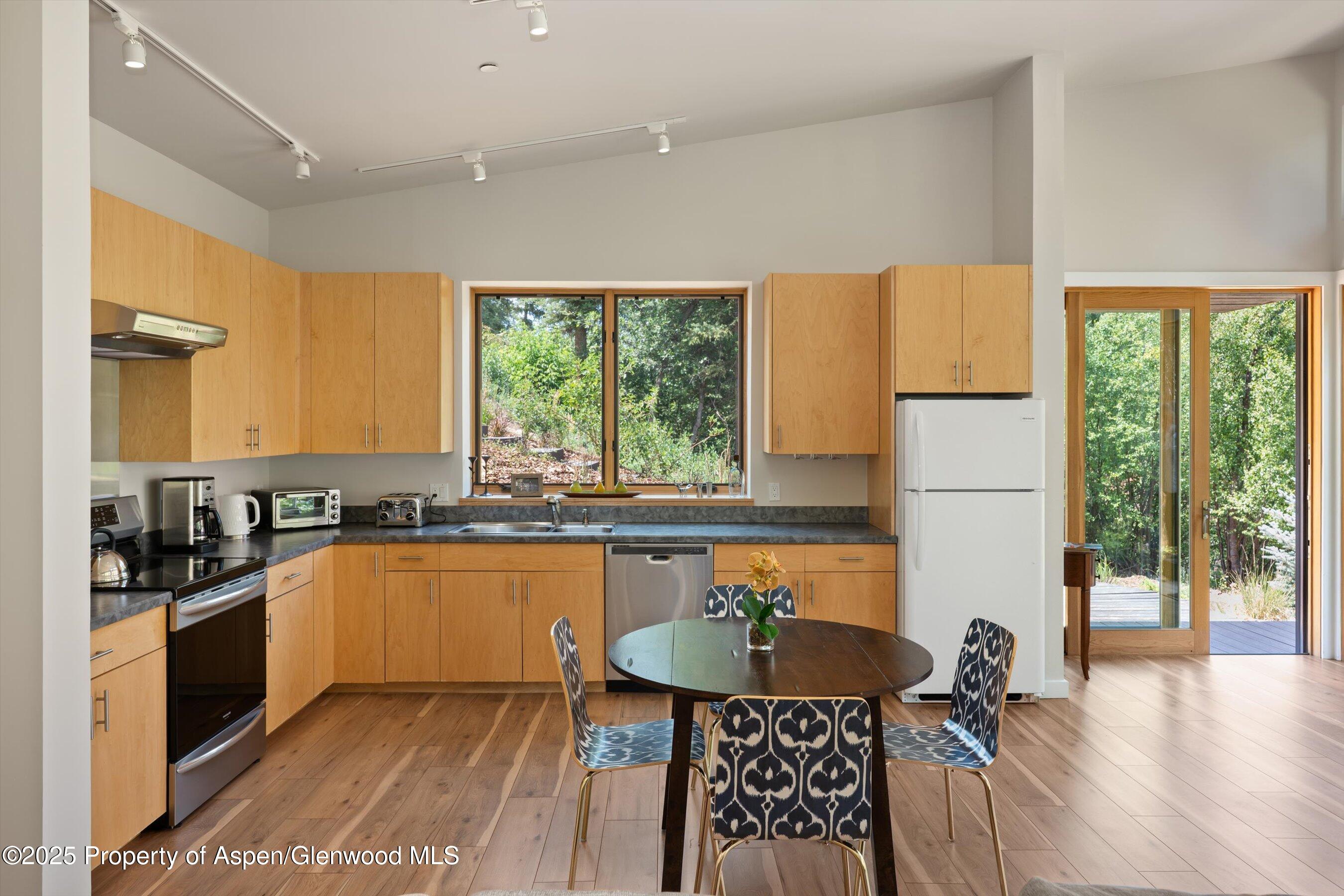 768 Kings Lake Road Basalt, CO 81621 - Photo 7 of 42 a kitchen with sink a window and chairs