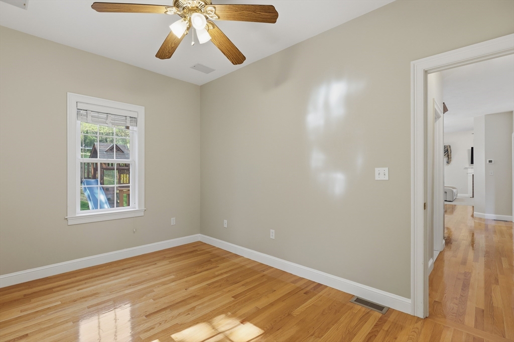 61 Indian Head Road Framingham, MA 01701 - Photo 18 of 42 a view of empty room with wooden floor and fan