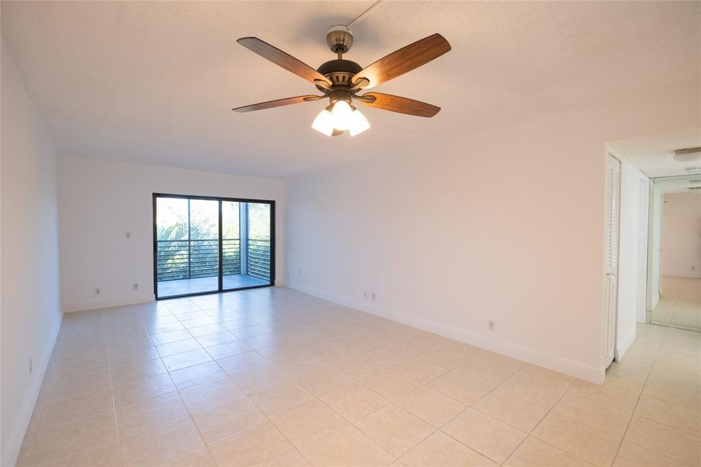 9233 Southwest 8th Street, Unit 222 Boca Raton, FL 33428 - Photo 19 of 29 an empty room with fan and windows