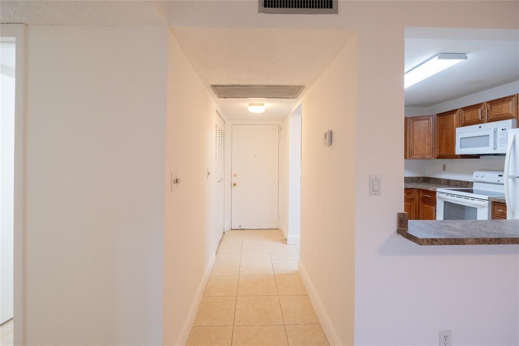 9233 Southwest 8th Street, Unit 222 Boca Raton, FL 33428 - Photo 20 of 29 a view of a kitchen from the hallway
