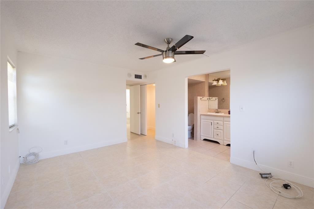 9233 Southwest 8th Street, Unit 222 Boca Raton, FL 33428 - Photo 27 of 29 a view of a livingroom with a ceiling fan and refrigerator