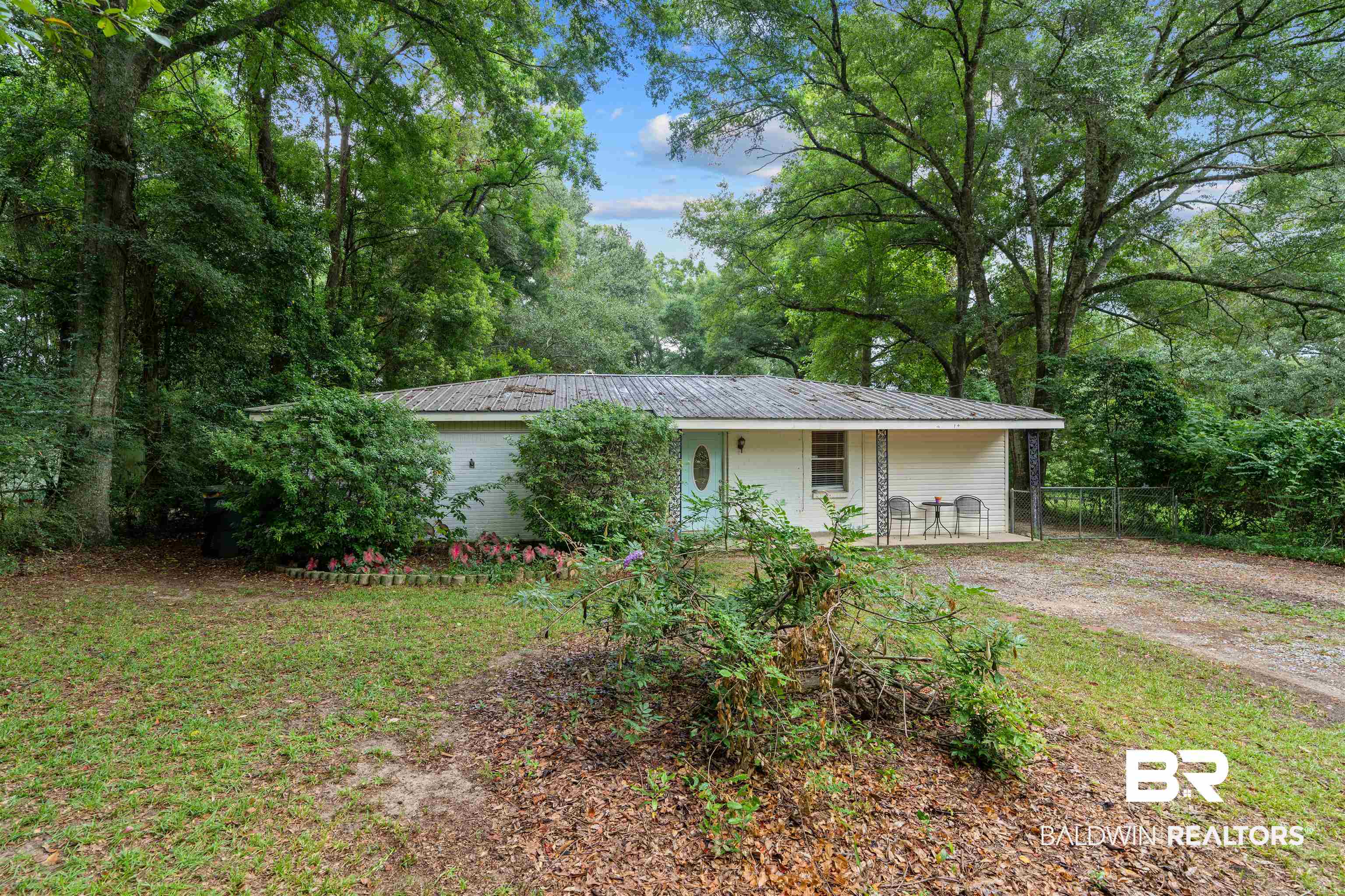 922 Dauphine Circle Daphne, AL 36526 - Photo 28 of 29 View of front of home featuring a metal roof and dirt driveway