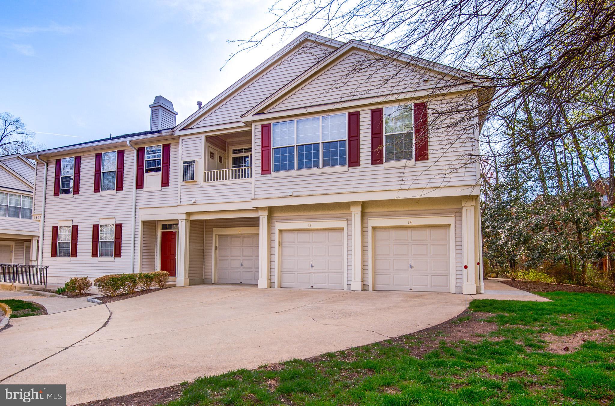 11407 Gate Hill Place, Unit 112 Reston, VA 20194 - Photo 24 of 28 a view of a house with a yard and garage