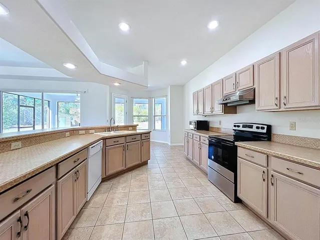 a utility room with cabinets and washer