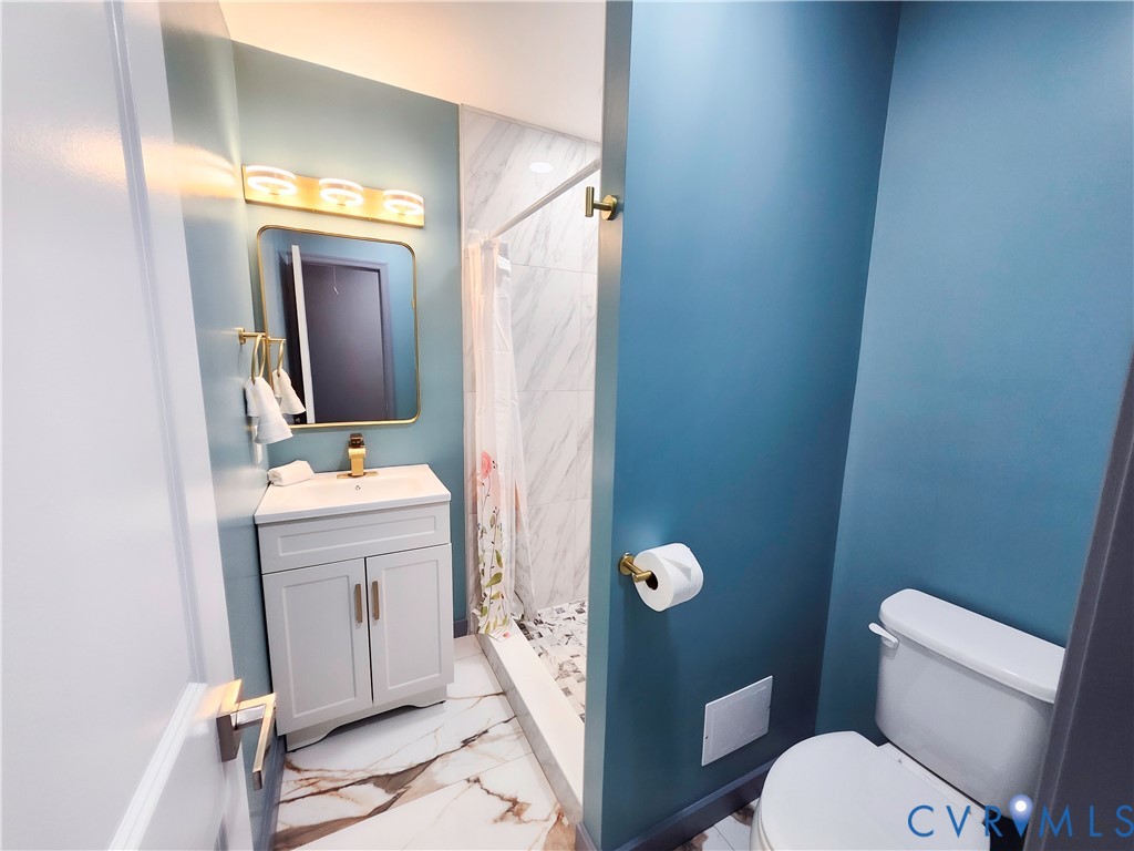 4060 Norborne Road Richmond, VA 23234 - Photo 15 of 24 Hallway full bathroom with light marble finish flo