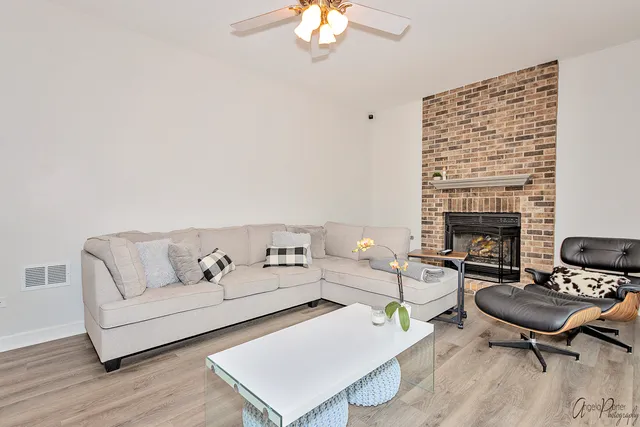 a living room with furniture a fireplace and a table