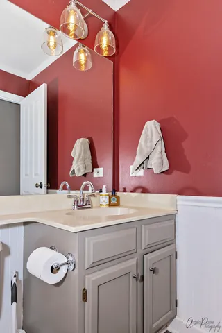 a bathroom with a sink vanity and a mirror