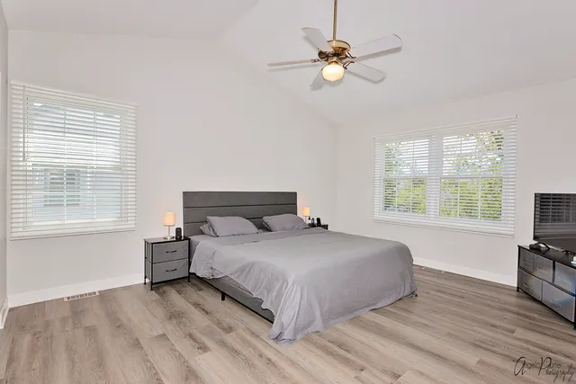 a bedroom with a bed and a chandelier