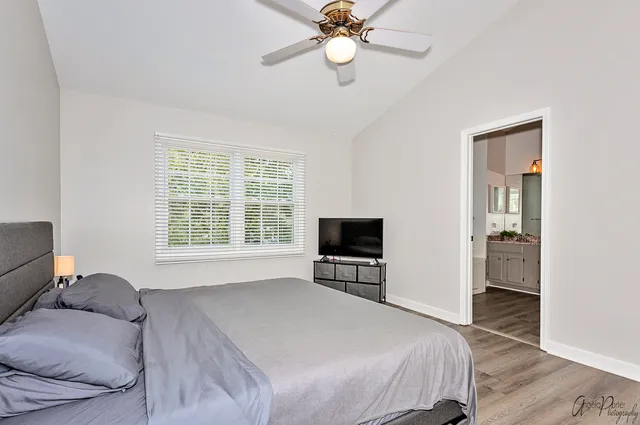 a bedroom with a bed and a television