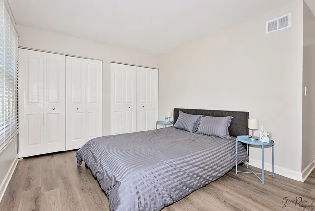 a bedroom with a bed and a night stand