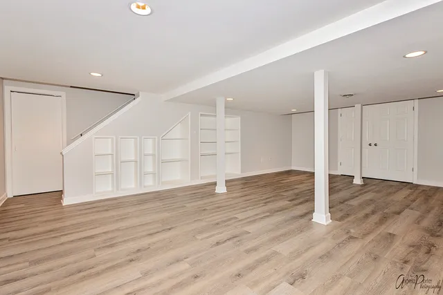a view of an empty room with wooden floor