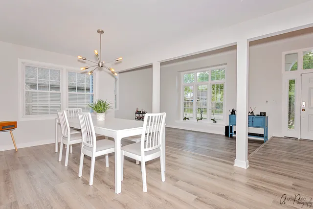 a view of a dining room with furniture window and wooden floor