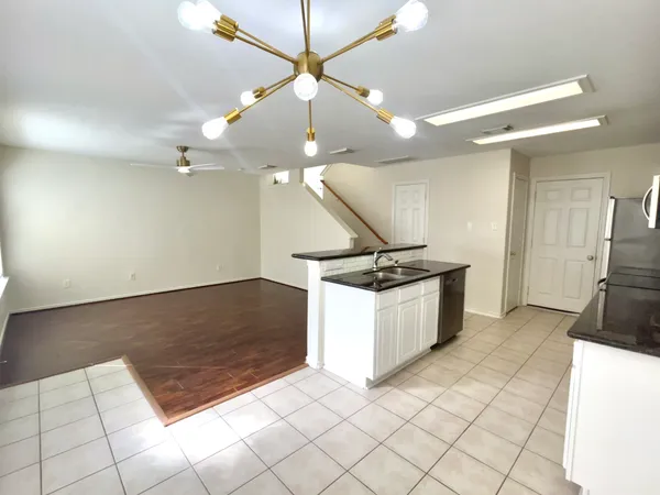 a kitchen with granite countertop a stove and a sink