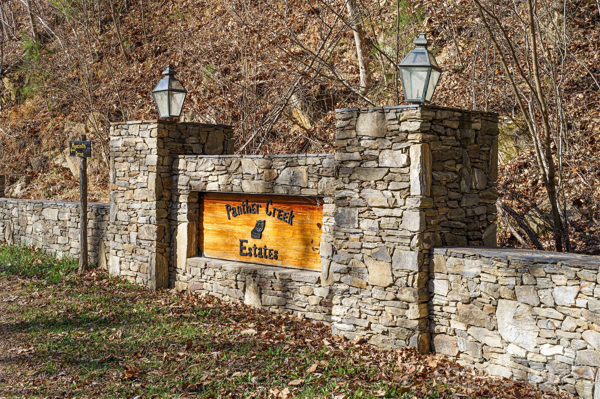 a view of a brick house with large trees
