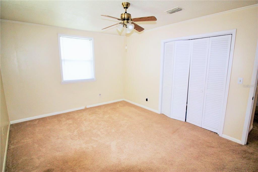 521 20th Street Southwest, Unit C Winter Haven, FL 33880 - Photo 7 of 18 an empty room with a window and a fan