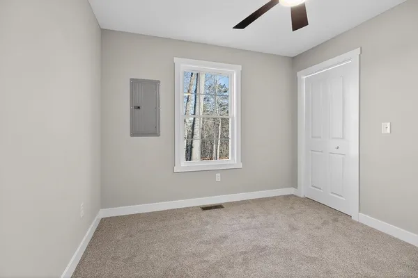 an empty room with windows and closet