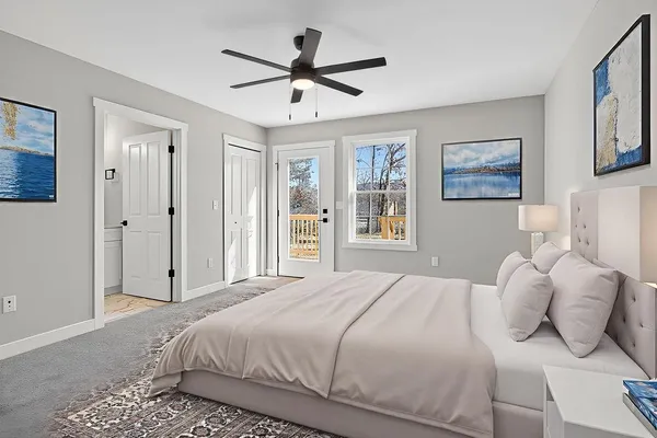 a bedroom with a large bed and a ceiling fan