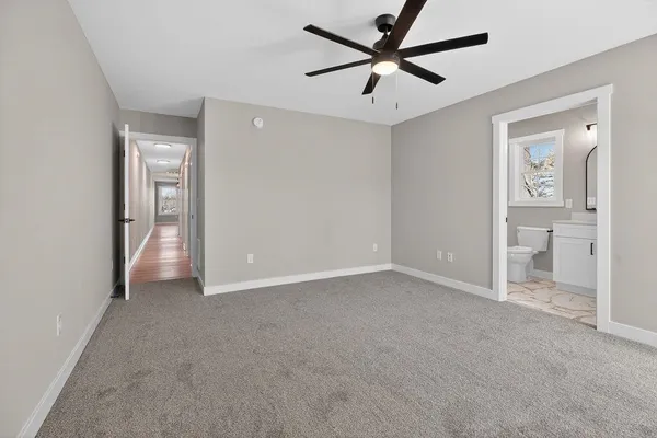 a view of a big room with closet and a ceiling fan