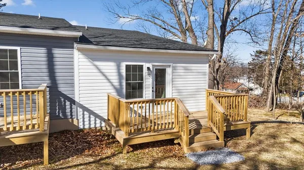 a view of a house with a bench in the patio