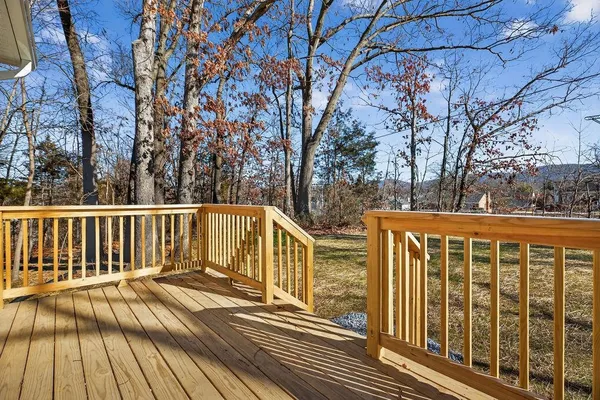 a view of balcony with wooden floor and fence