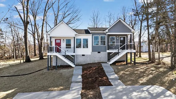 a front view of a house with a yard outdoor seating and barbeque oven