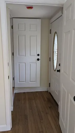 a view of a livingroom with wooden floor and white doors