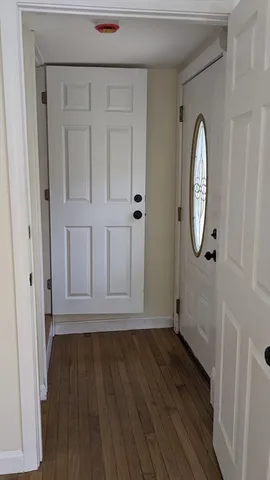 a view of a livingroom with wooden floor and white doors