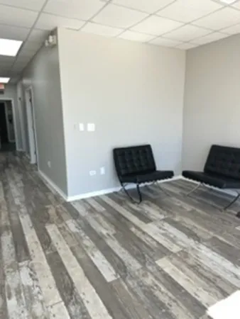 a bedroom with a bed and a chair