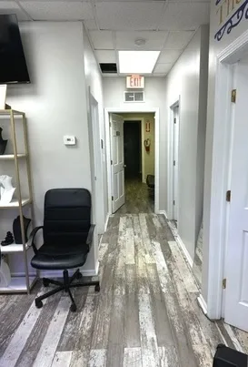 a view of a hallway with furniture and a rug