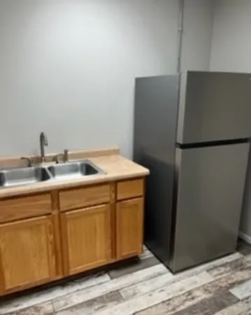 a kitchen with a refrigerator and a sink