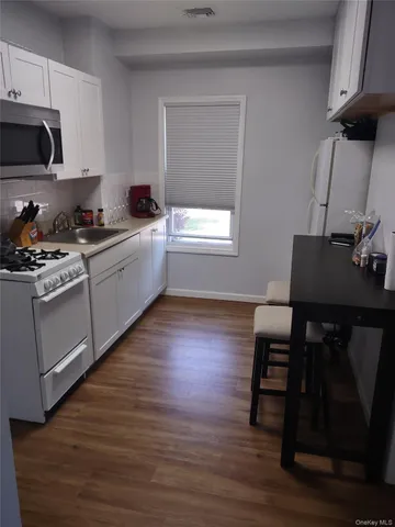 a kitchen with a table chairs and a stove