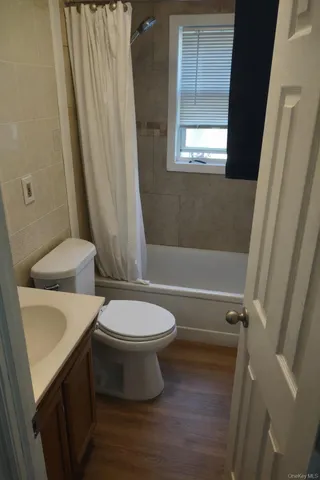 a white toilet sitting next to a bath tub