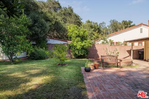 a backyard of a house with yard and outdoor seating
