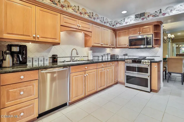 a spacious bedroom with a large bed and a chandelier