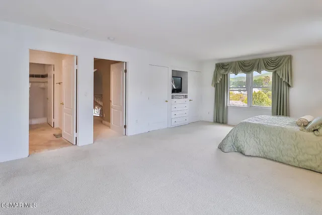a living room with furniture a flat screen tv and wooden floor
