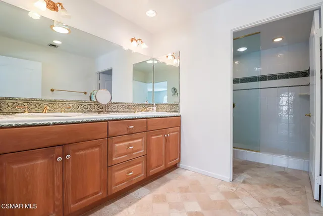 a hall with wooden floor and cabinets