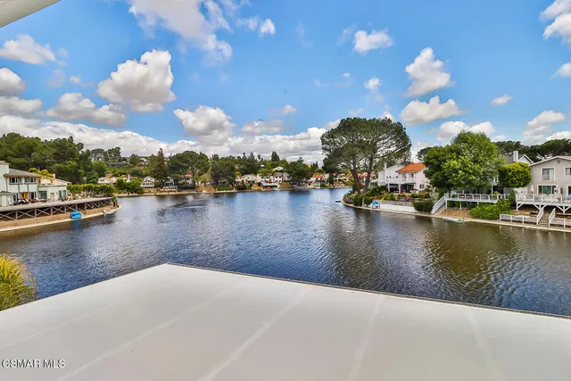 a kitchen with stainless steel appliances granite countertop a lot of counter space and wooden floors