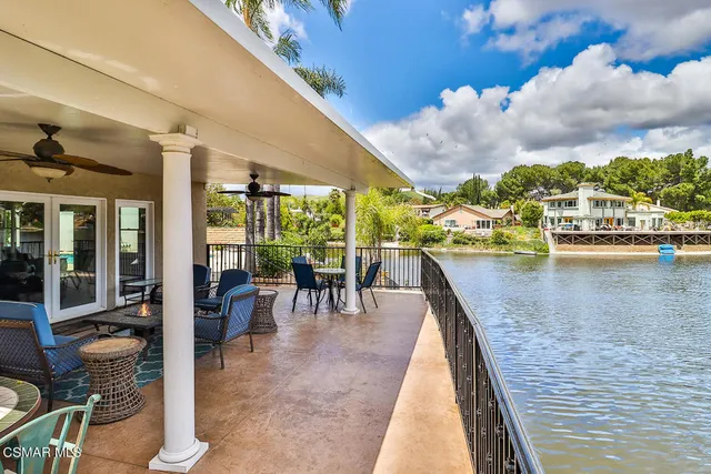 a view of a hallway with wooden floor and furniture