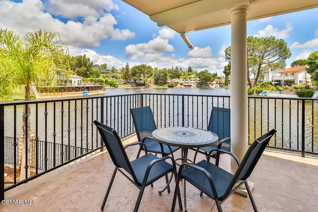 a bathroom with a granite countertop toilet sink and mirror