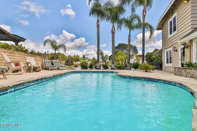 a large kitchen with stainless steel appliances granite countertop a refrigerator and a stove top oven