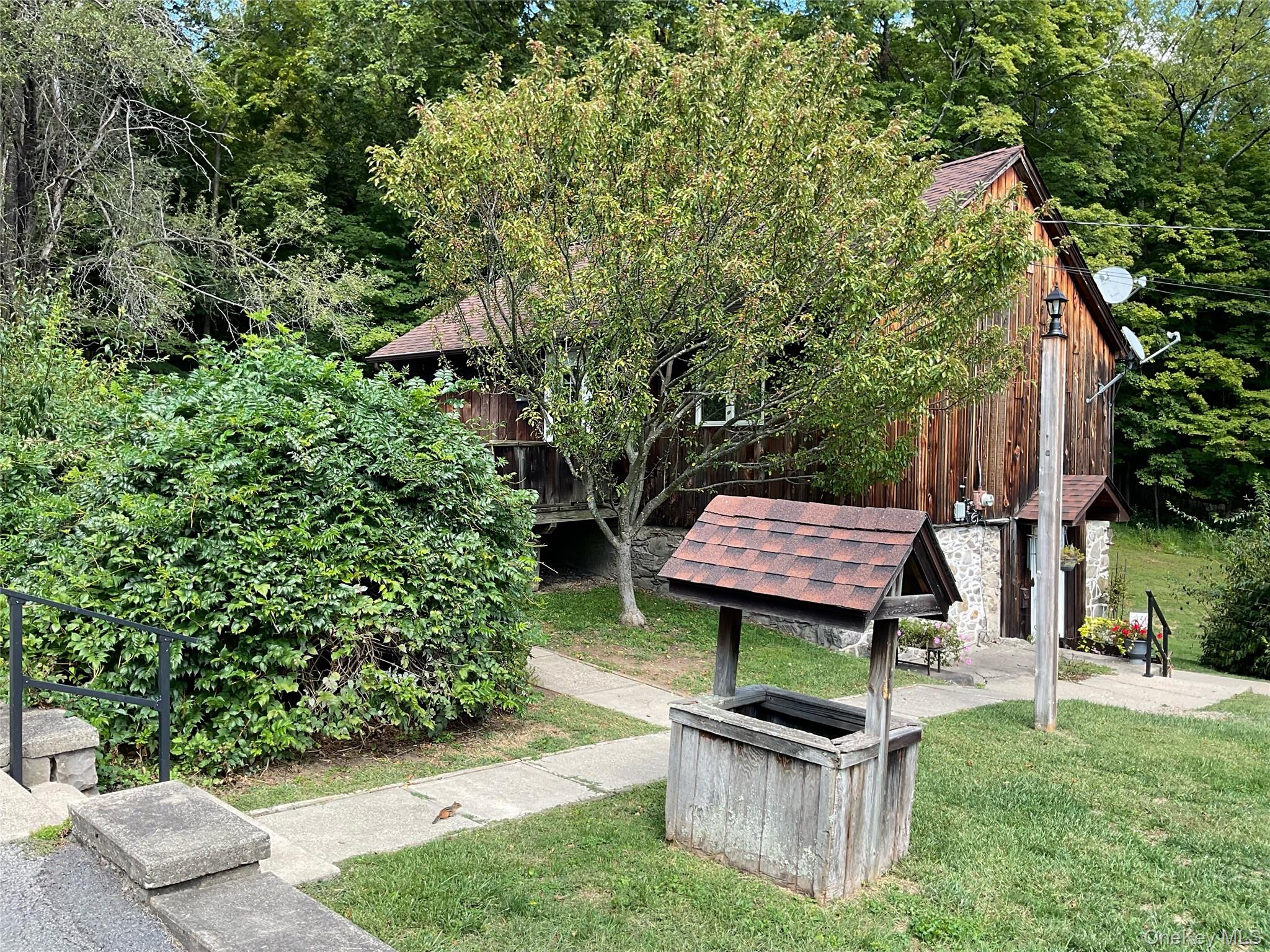 a view of a garden with wooden fence