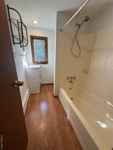 a bathroom with a bathtub a toilet and a shower