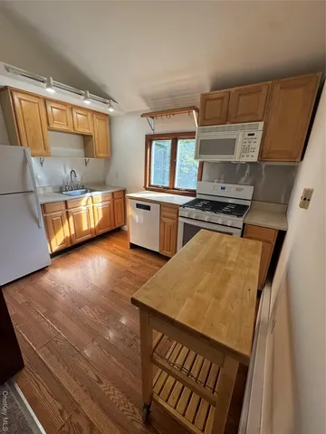 a kitchen with a stove a sink and a microwave