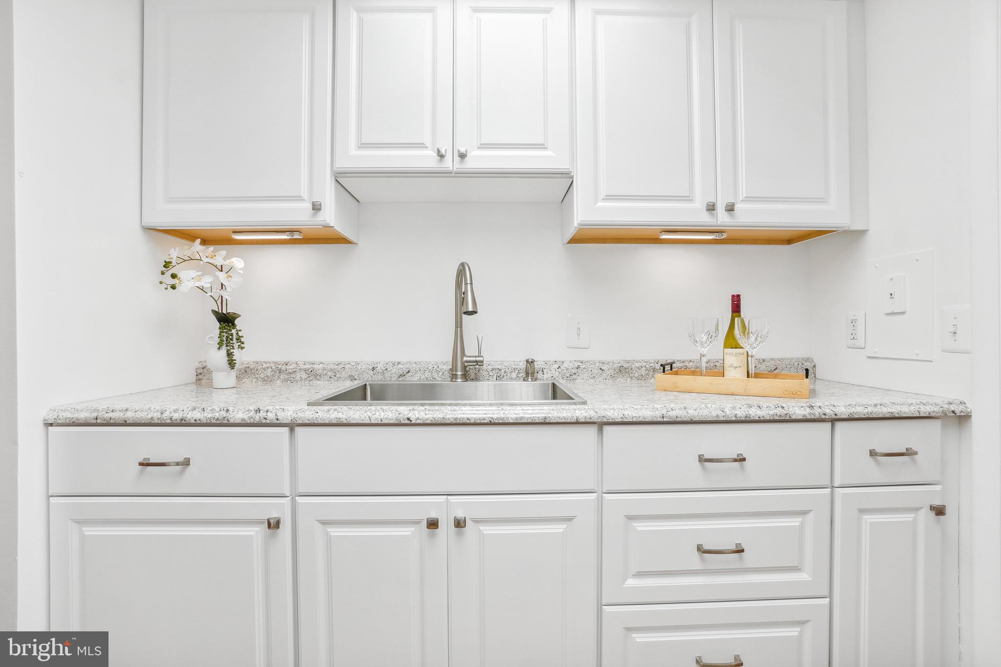 3350 Chiswick Court, Unit 573C Silver Spring, MD 20906 - Photo 8 of 43 a kitchen with white cabinets and a sink